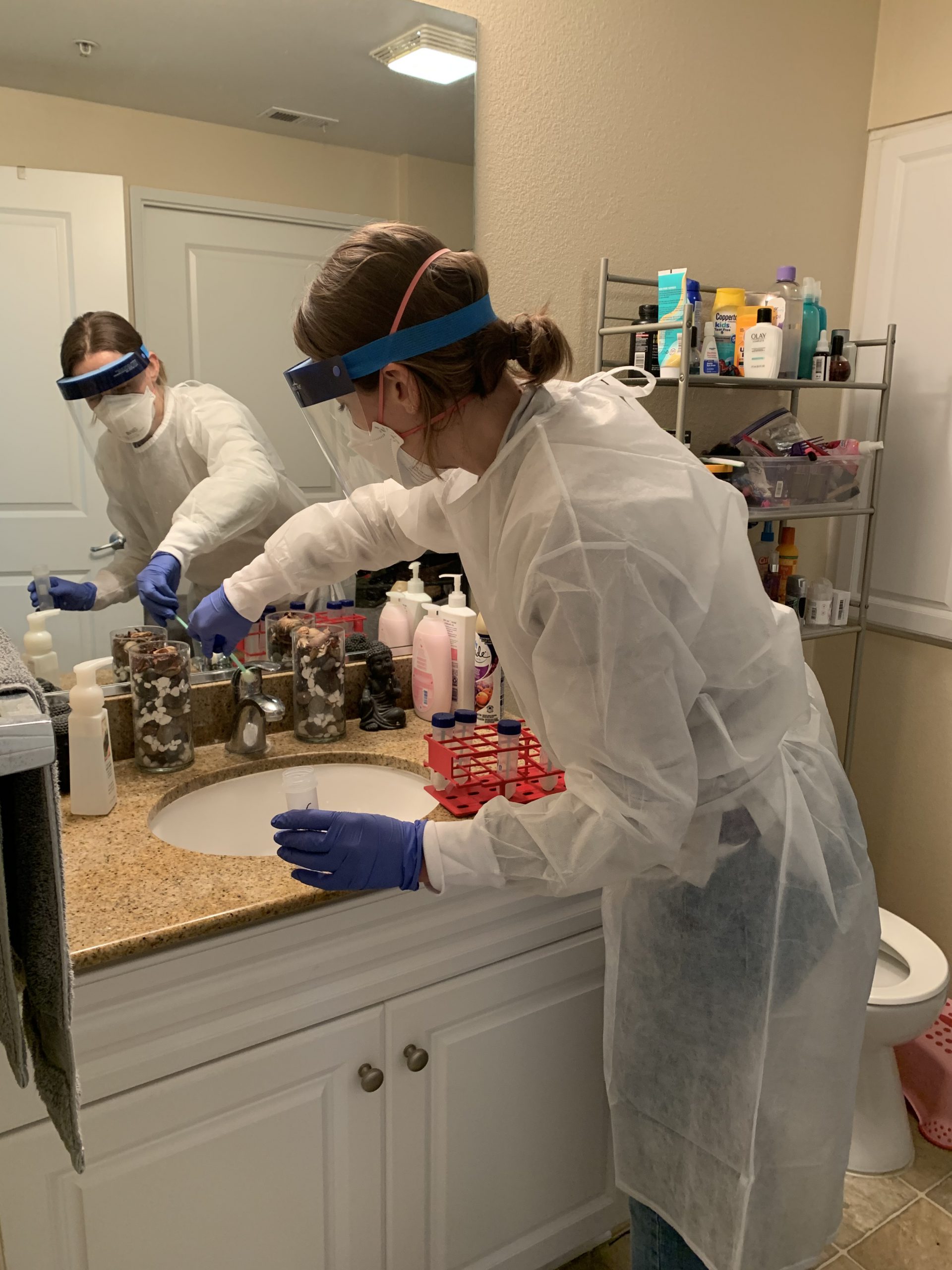 EIS Officer Marisa Donnelly samples bathroom surfaces to detect the virus that causes COVID-19 in order to understand more about transmission risk in February 2021.