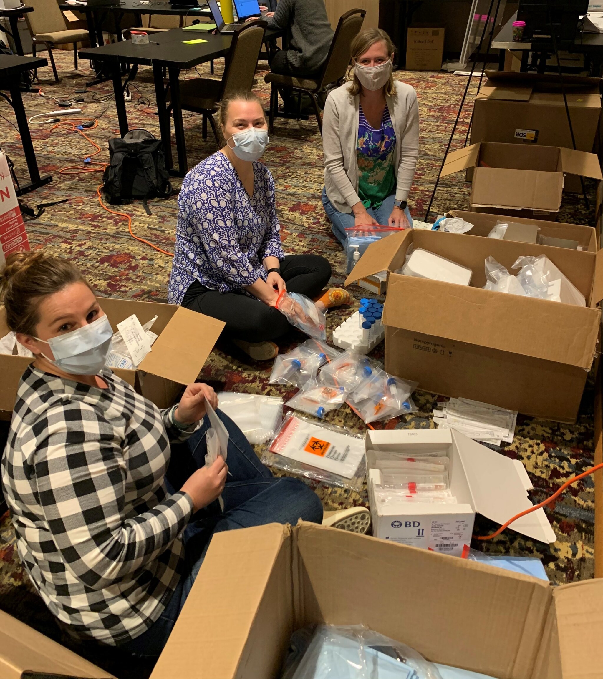 EIS officers Caroline Pratt and Stacey Konkle, along with CDC’s Dana Haberling, sort specimen collection supplies for a COVID-19 household transmission study in San Diego, CA in February 2021.
