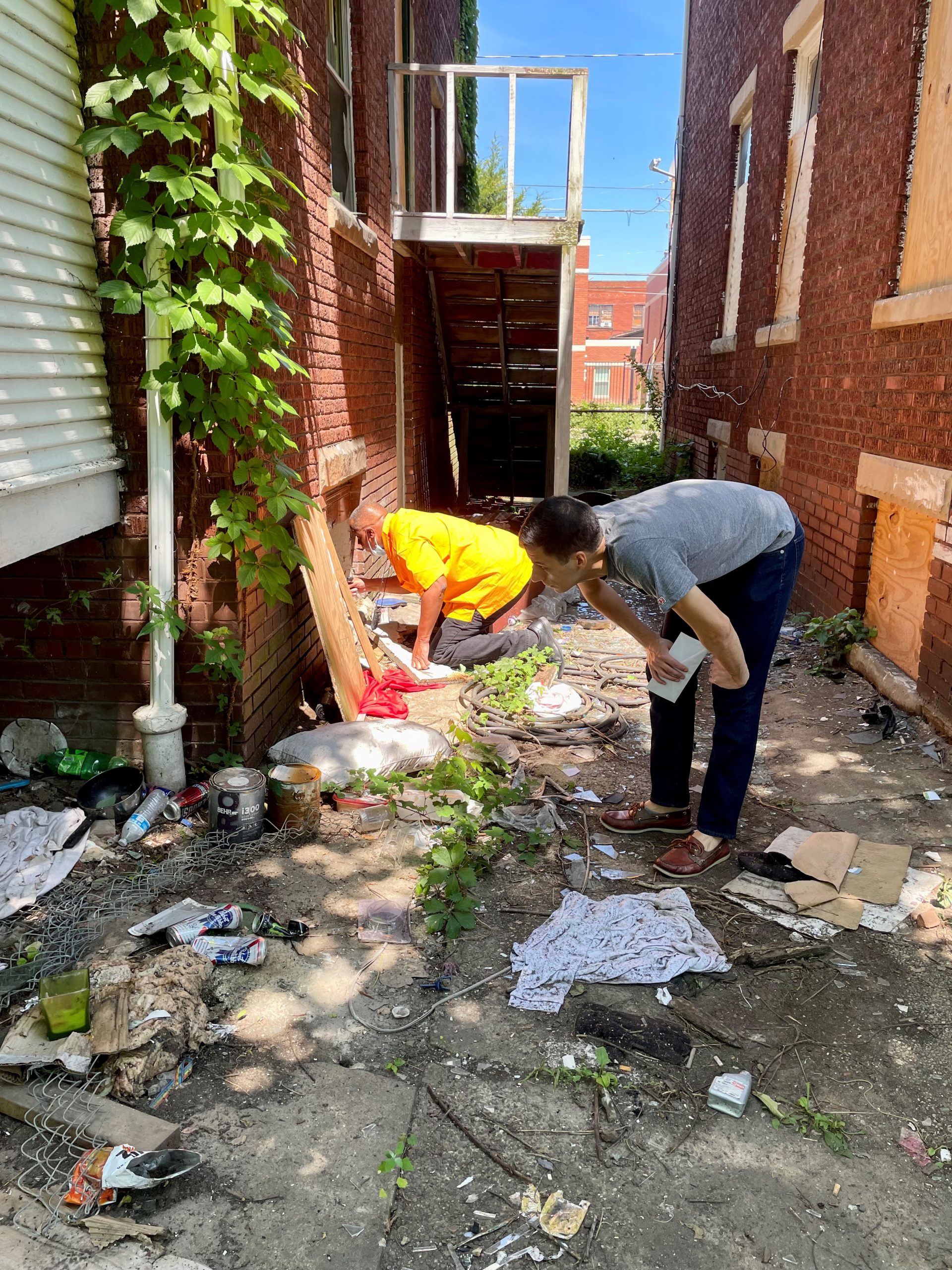 EIS officer Robert Bonacci (right) and DSTDP colleague Ken Myers (left) search abandoned homes while doing street outreach during an HIV outbreak among people who inject drugs in Kanawha County, West Virginia in June 2021.