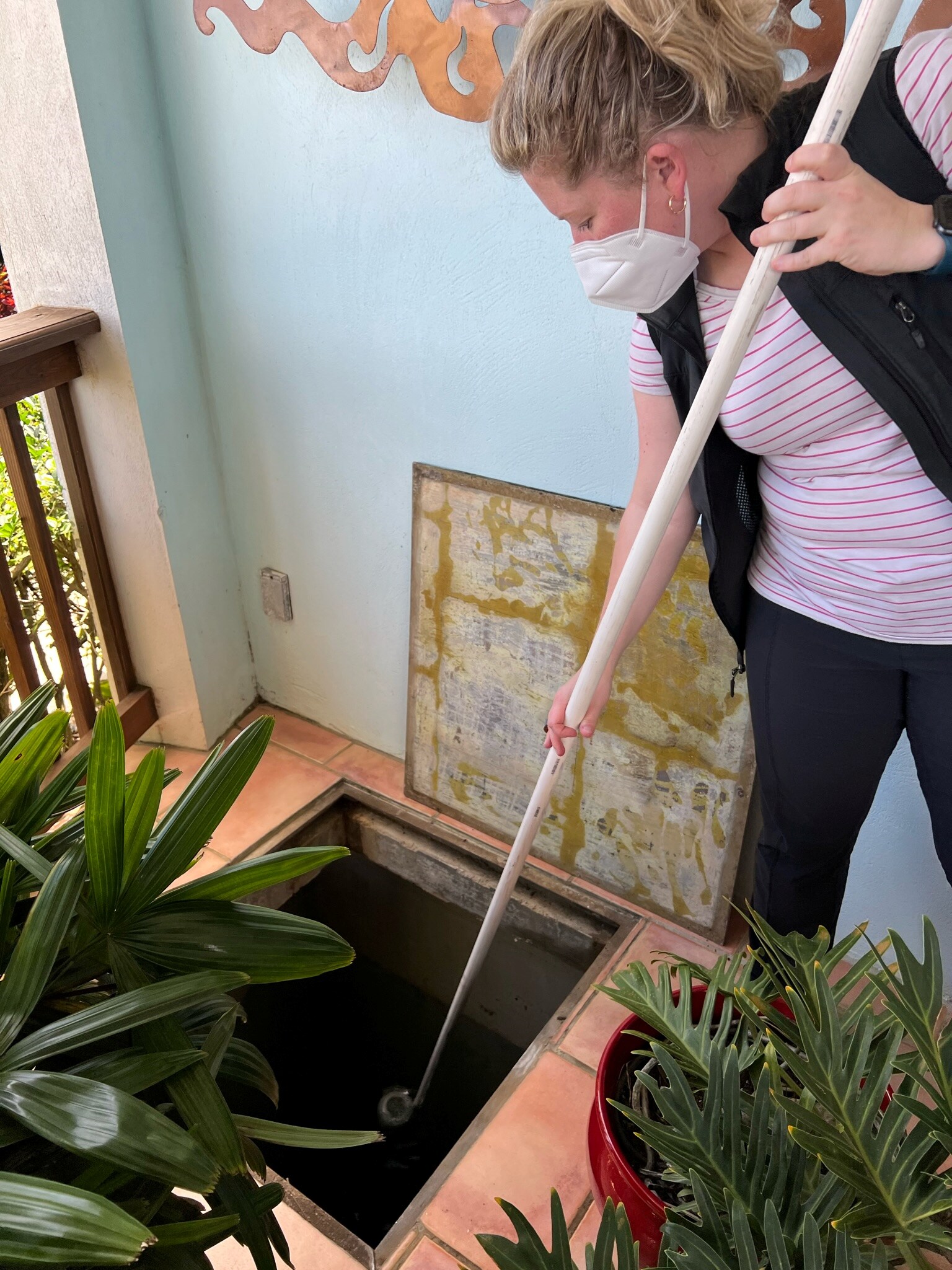 EIS officer Heidi Moline samples water from an underground cistern for a <em>Legionella</em> investigation in February 2022.
