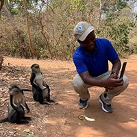 Daniel Owusu taking pictures with monkeys