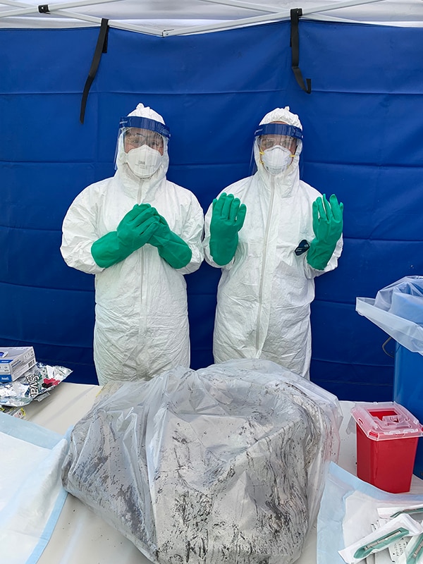 EIS officer Julia Petras (2021) and LLS fellow Maureen Ty (2021) obtain samples during a follow-up investigation.