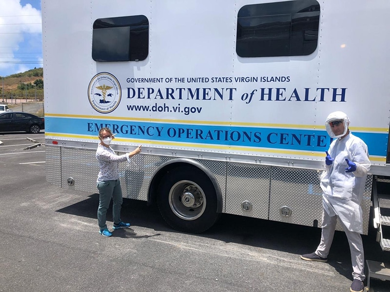 EIS Officer and supervisor get ready in front of a mobile Emergency Operations Center in the U.S. Virgin Islands.