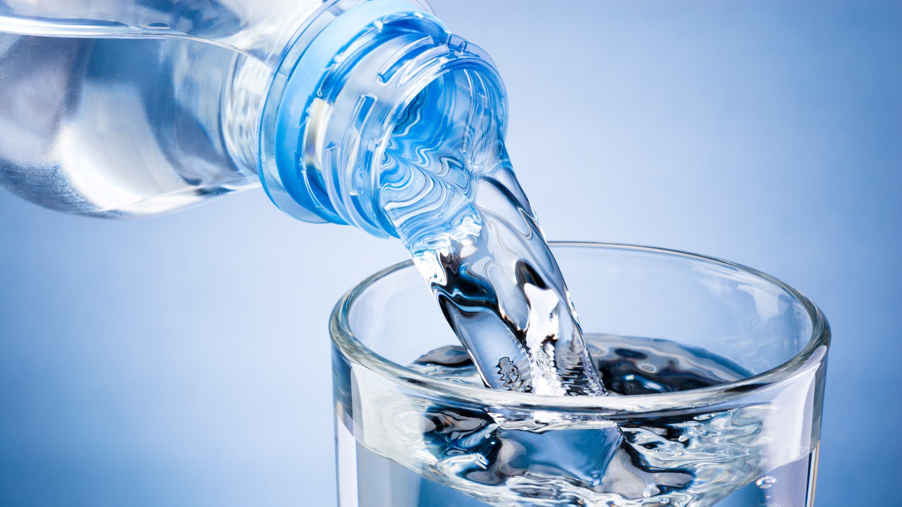 Bottled water being poured into a glass