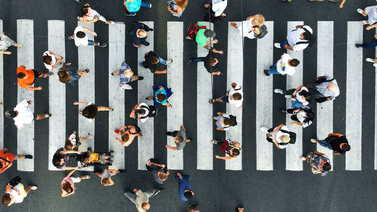 Overhead view of many people using a city crosswalk