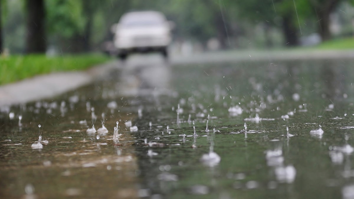 Raindrops splashing onto pavement