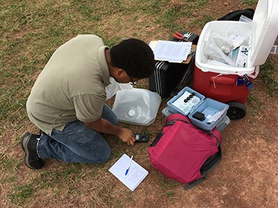 EIS field worker taking mitchell field test
