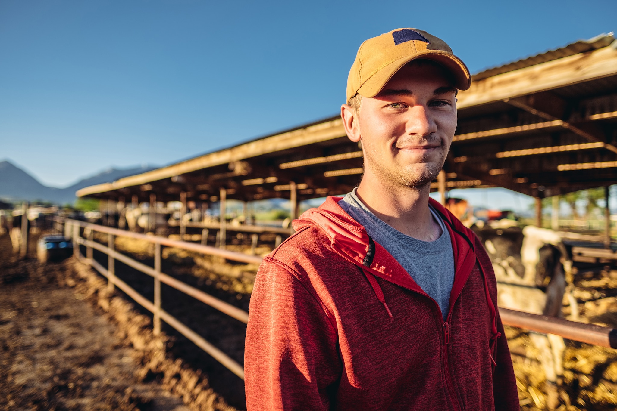 Young dairy farmer standing on a farm