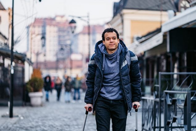 Man using walking canes for walking downtown injured