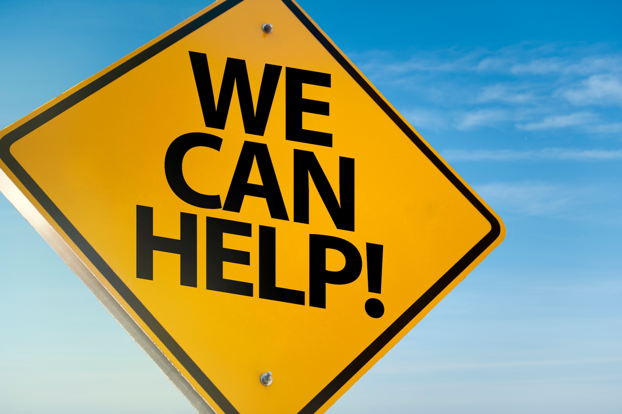 Schild mit der Aufschrift 'Wir können helfen!''We Can Help!'