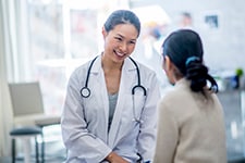 Doctor smiling, talking to patient