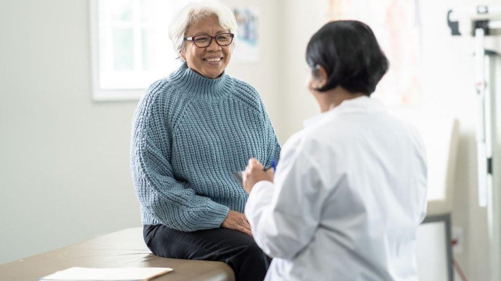 Senior woman discusses with doctor