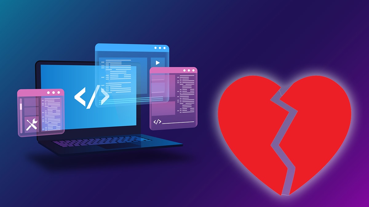 Computer monitors with code and a broken heart.