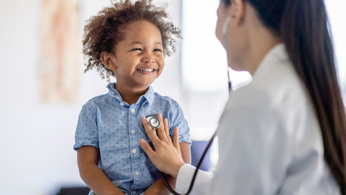 Healthcare provider listening to a child's breathing with a stethoscope