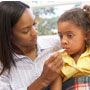 Mother taking daughter's temperature