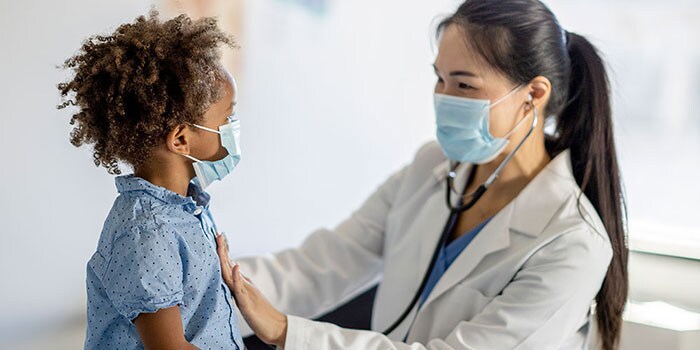 Doctor assists young child