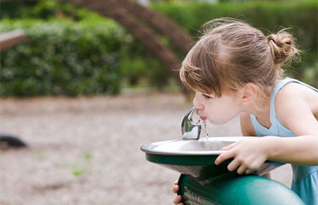 Girl drinking from water fountain