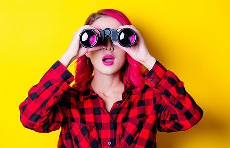 Colorful photo of young woman looking through binoculars