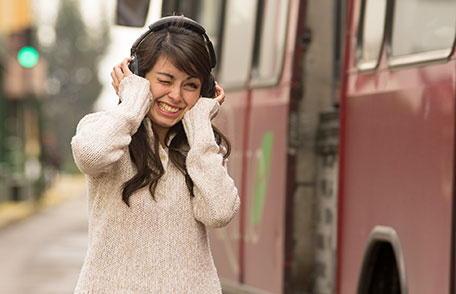 Illustration of young woman wearing headphones and smiling