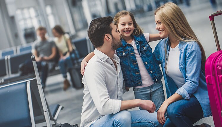 a family with their child ready to board a plane