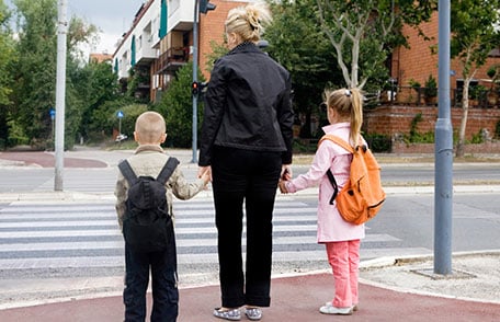 Mother about to cross road with son and daughter