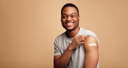 Portrait Of Vaccinated African Man Showing His Arm