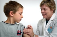Photo of a boy getting vaccinated against the flu.