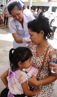 In Laos, a pregnant woman receives her seasonal flu shot.