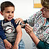 Take time to get a flu vaccine like this young boy from an older female nurse.
