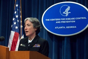 Dr. Anne Schuchat speaking at a podium during a press briefing.
