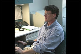 Terrence Tumpey typing at desk
