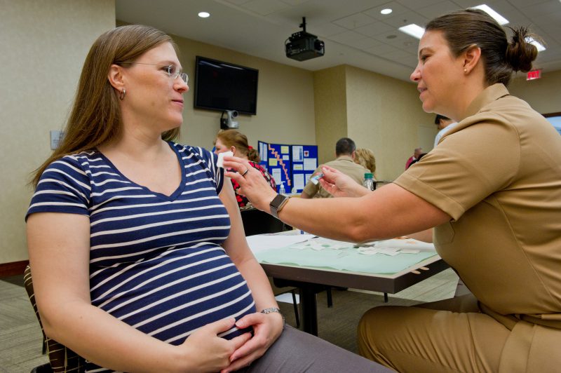 Pregnant woman receiving vaccination