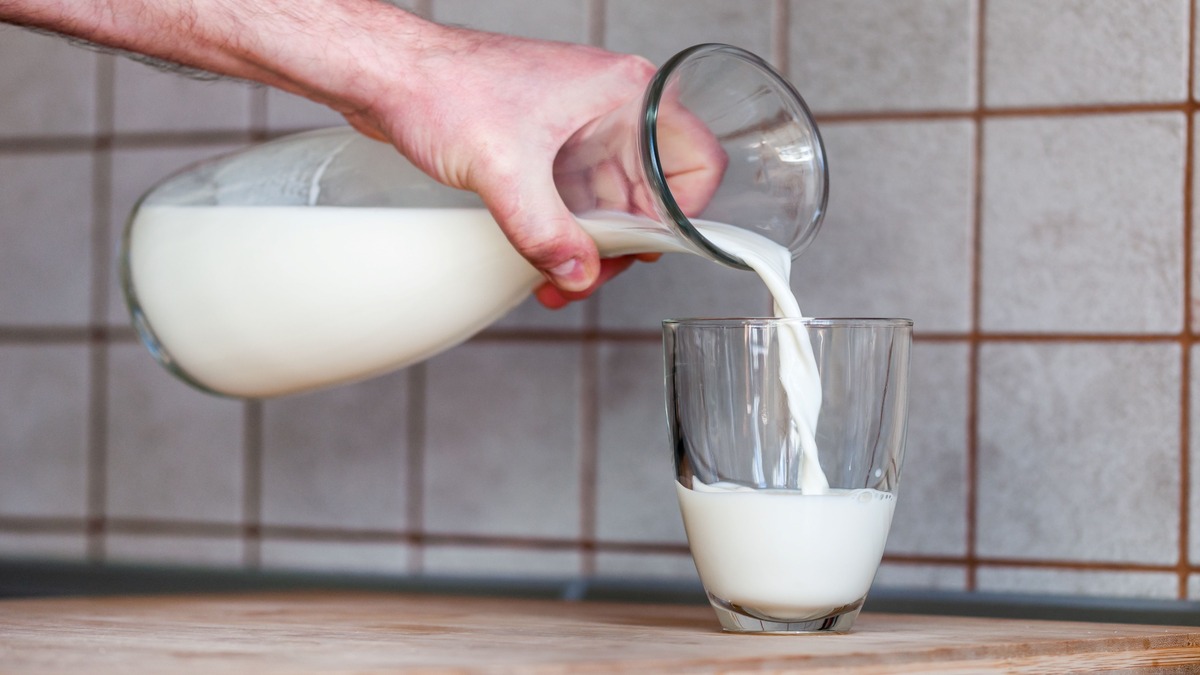 Milk being poured into a cup