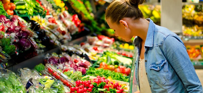 woman look at fresh vegetables in a grocery store