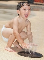 Young child playing in water.