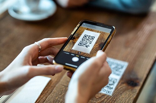 Person scanning a QR code with their phone