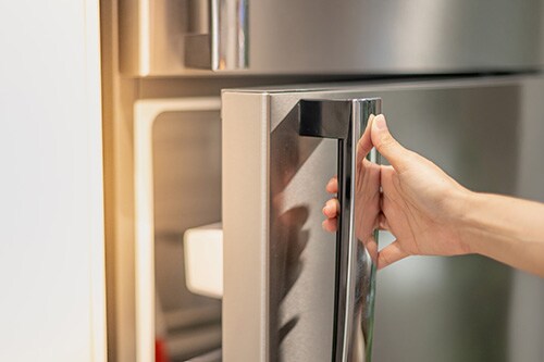 Person opening a refrigerator