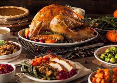 Display of turkey, green beans, stuffing, cranberries, and pumpkin pie