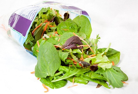 Close up of contents of open bag of salad.