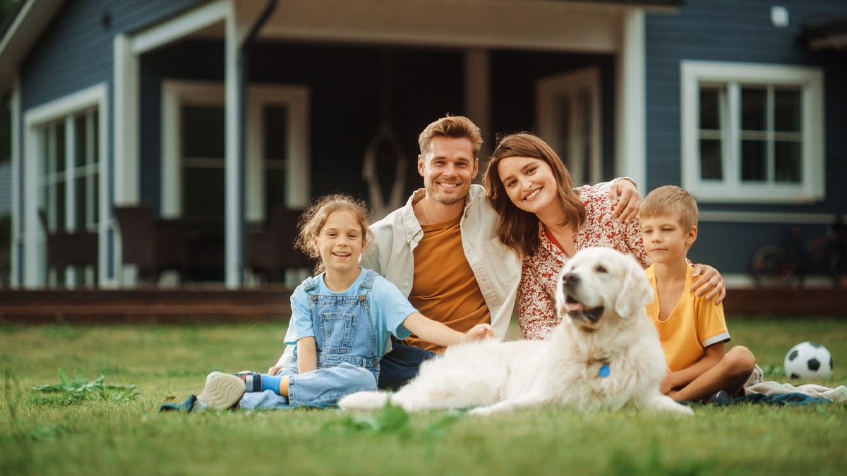 family sitting together with their dog, smiling