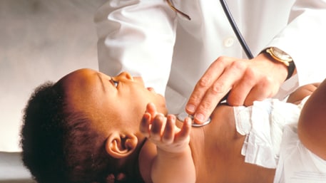 a doctor examining a newborn