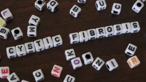 letter blocks are spelling out Cystic Fibrosis