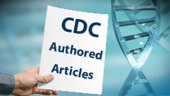 a hand holding a piece of paper with the text: CDC authored articles and DNA in the background