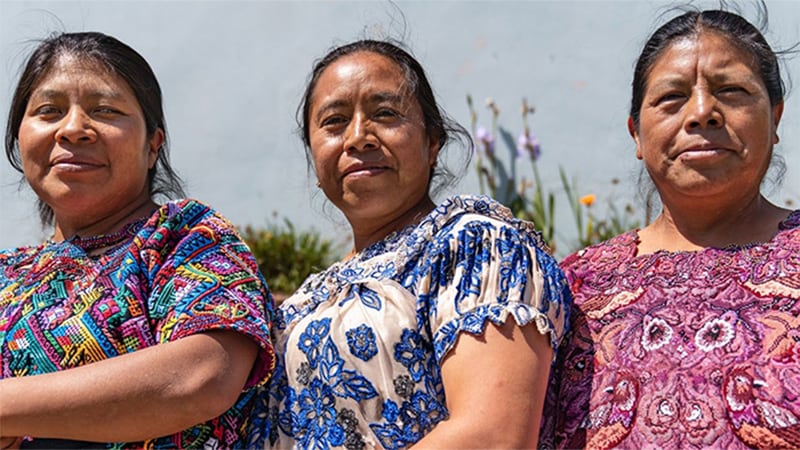 Three healthcare workers pose as they wait for training at a regional public health office in Quetzaltenango, Guatemala.