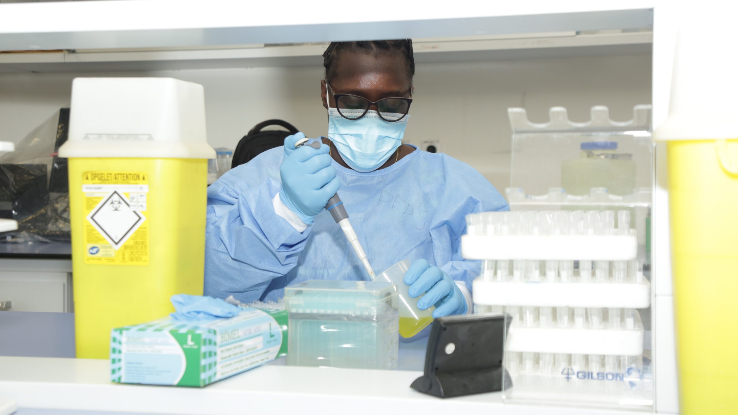 Photo of a laboratorian processing samples