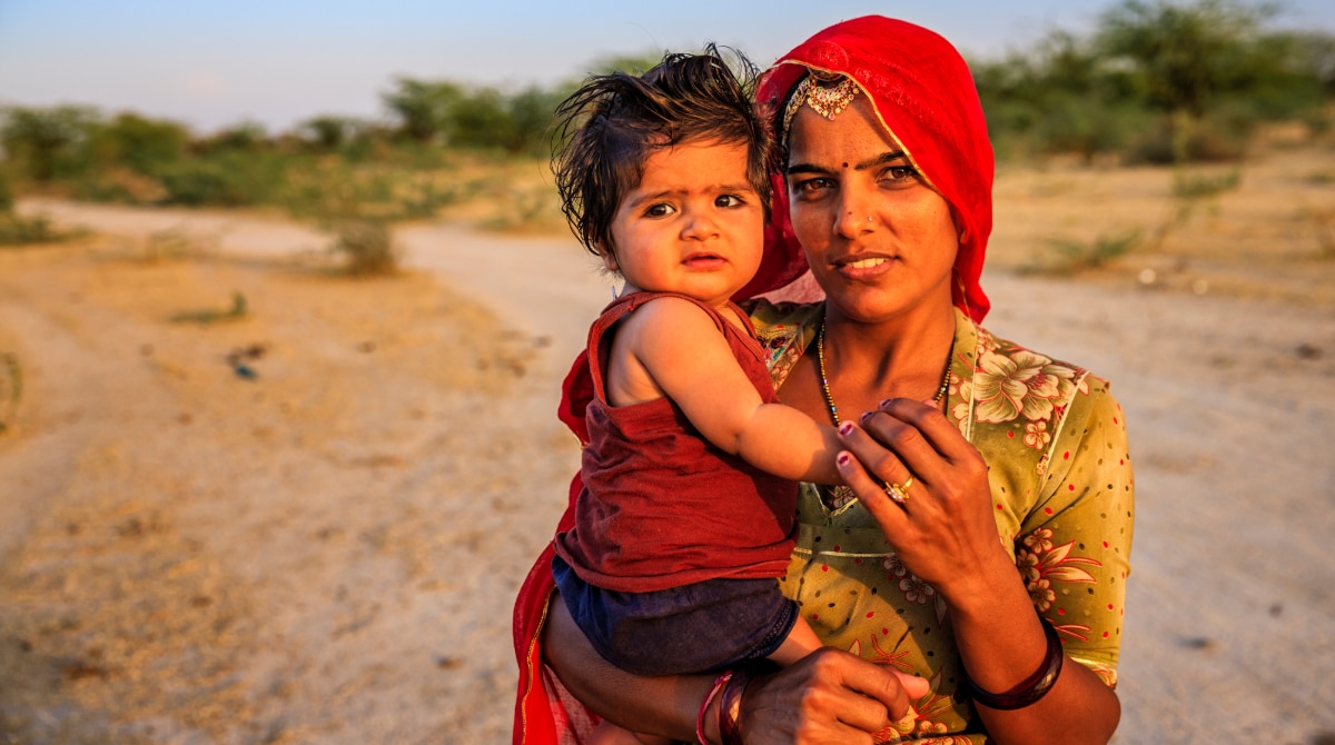 Woman with baby in desert location.