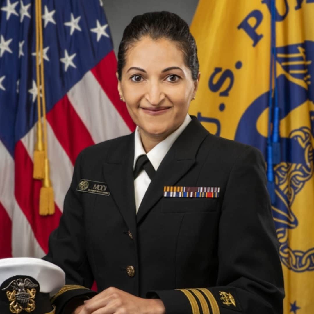 Woman in United States Public Health Service uniform smiling.