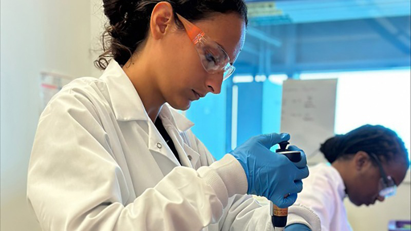 A lab worker in glasses and white coat