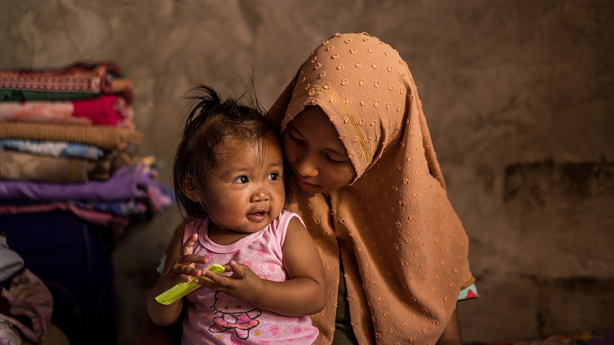 A woman in the Philippines holds her child.