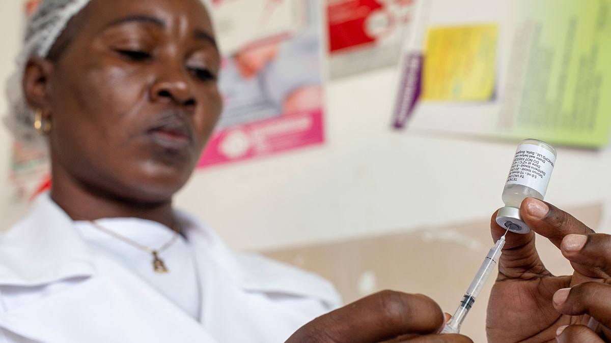 Woman preparing vaccine syringe